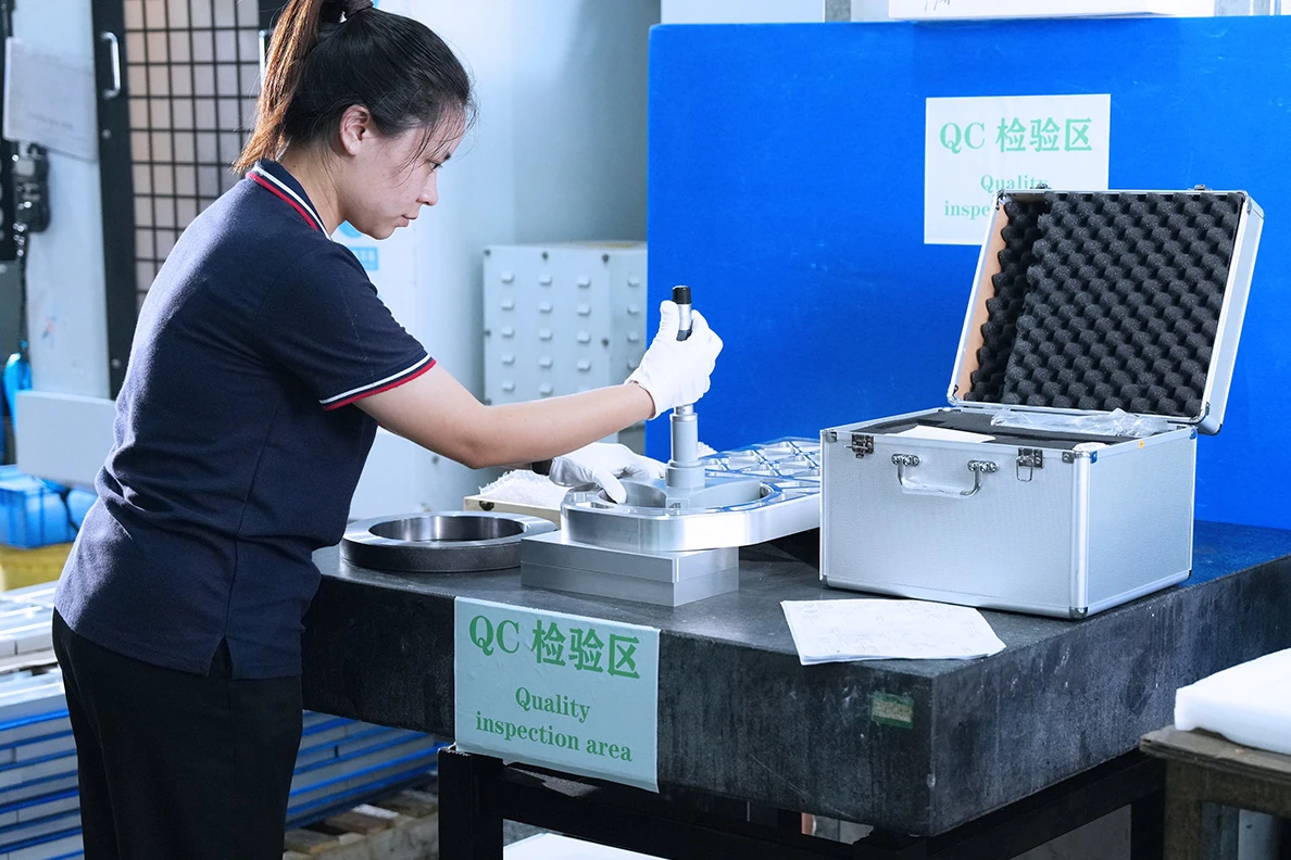 Inspector measuring a machined aluminium component