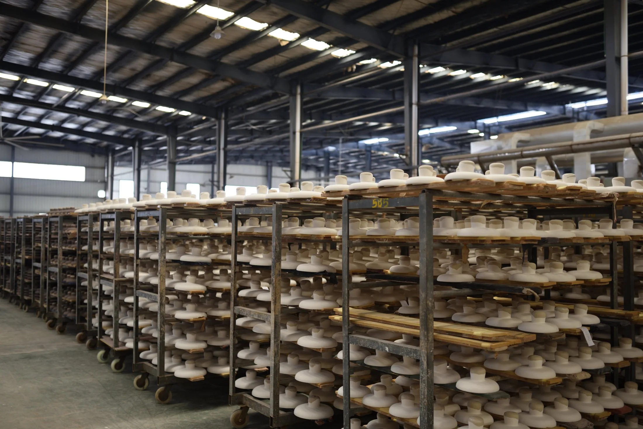 Insulator bodies arranged on workshop storage racks