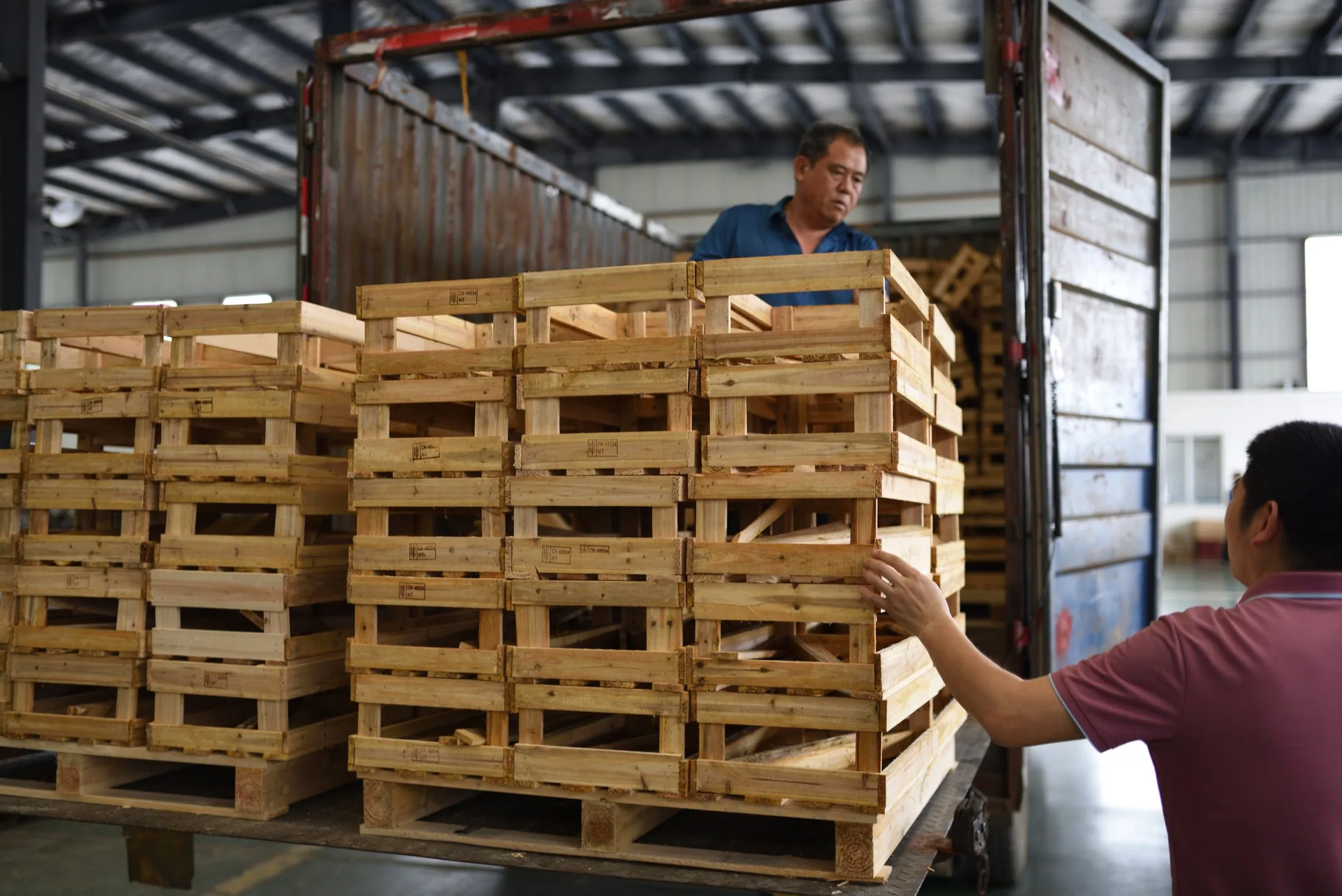 Wooden product crates being loaded in the workshop