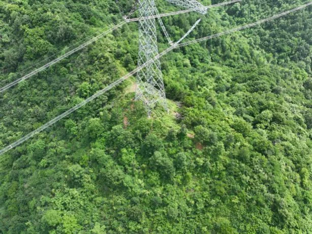 Aerial view of a UHVDC tower and conductor spans